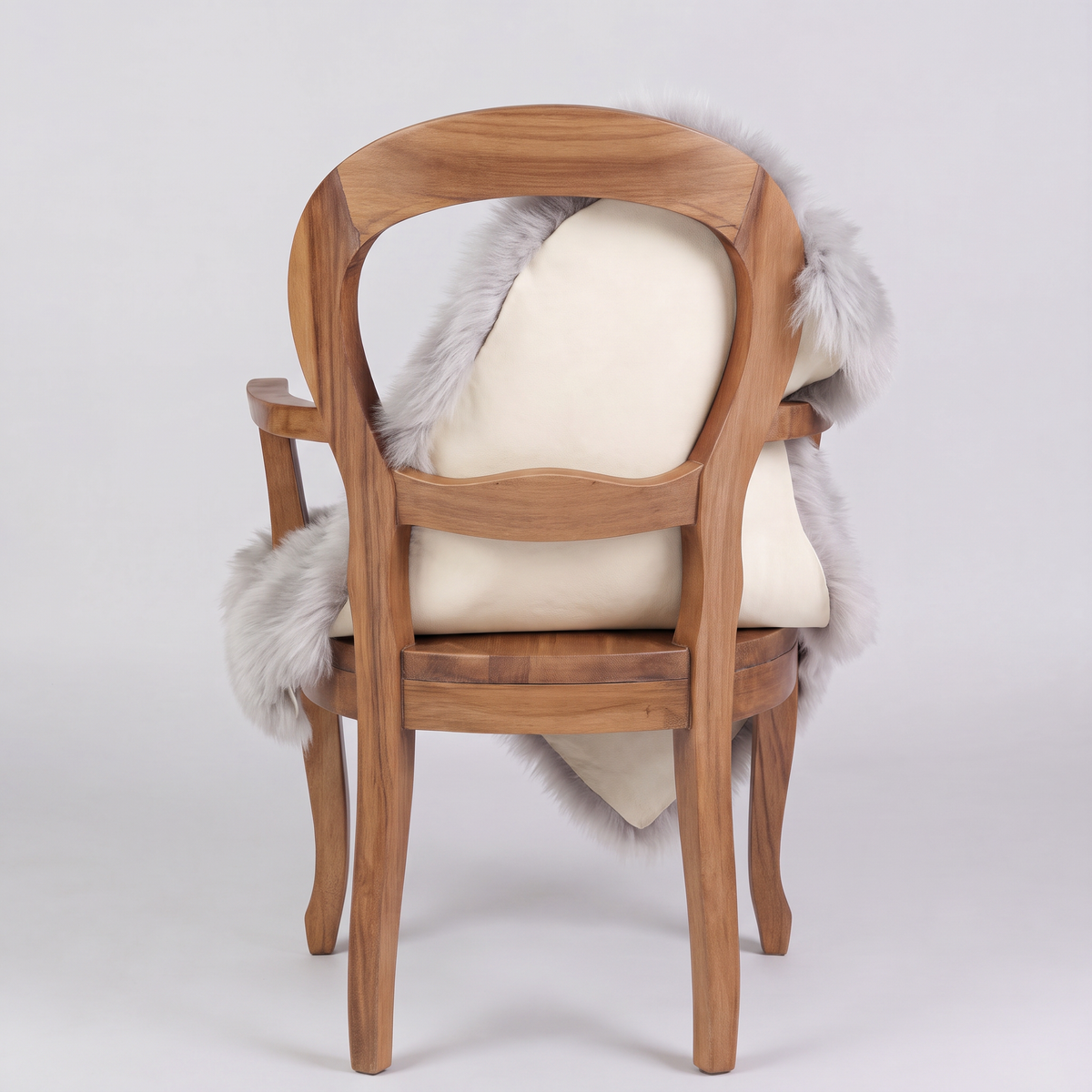 Light Grey sheepskin over an armchair back, suede leather underside facing the camera