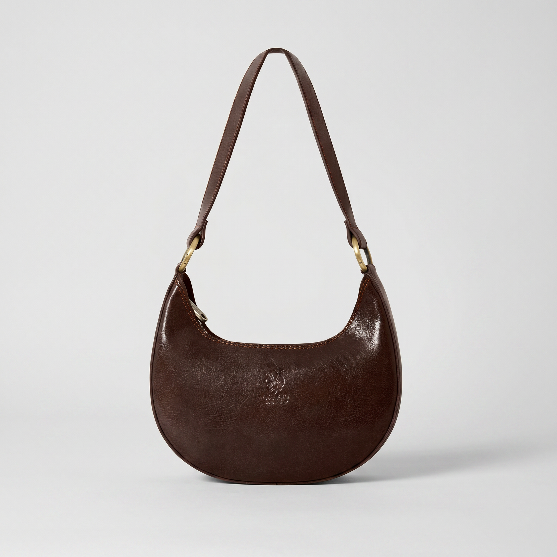 Mezzaluna leather shoulder bag in Dark Chocolate on light grey studio background