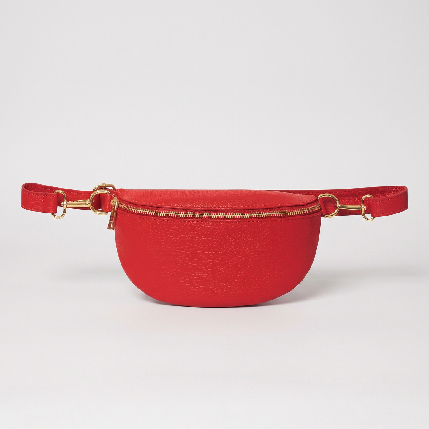 Romy leather crossbody bum bag in Red on light grey studio background