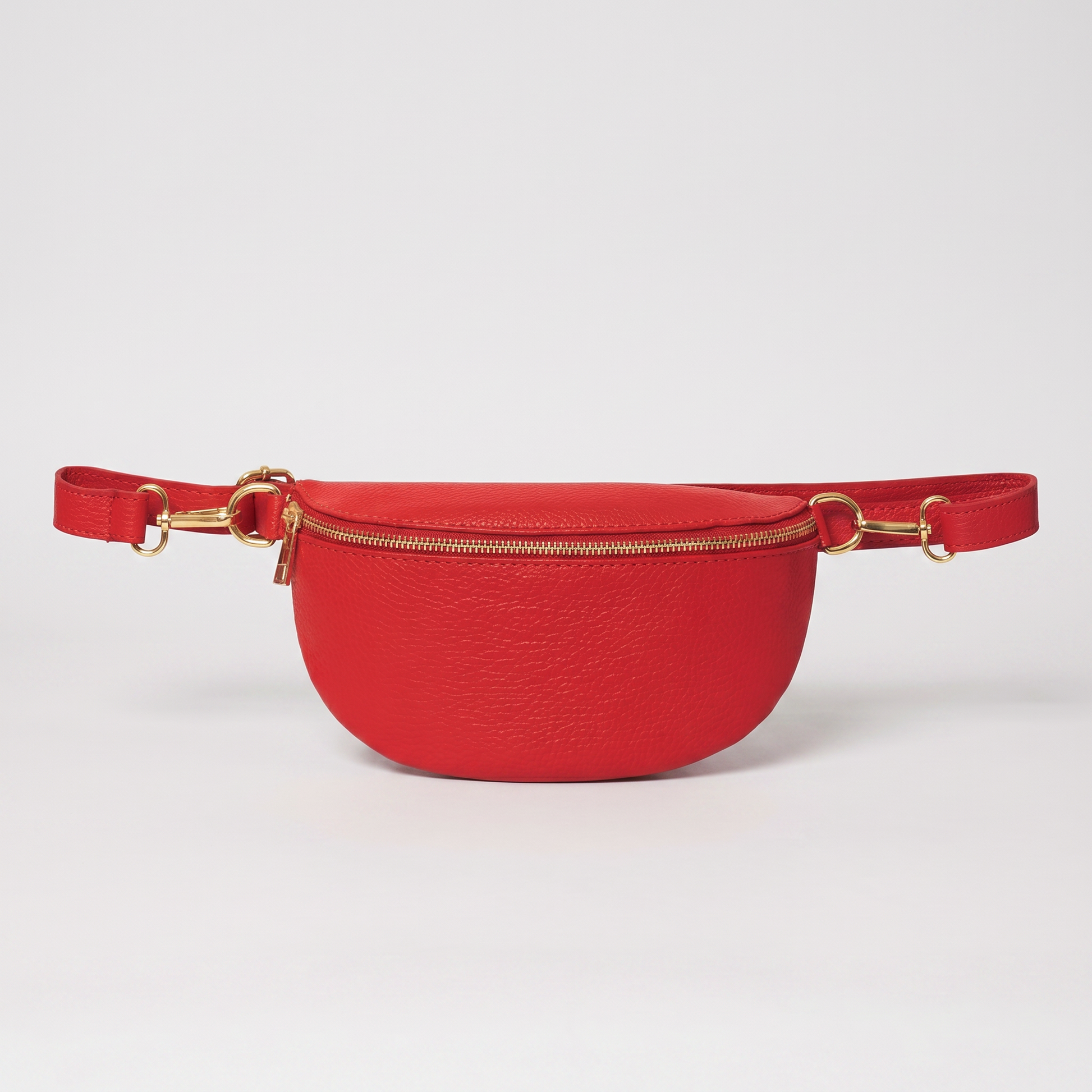 Romy leather crossbody bum bag in Red on light grey studio background