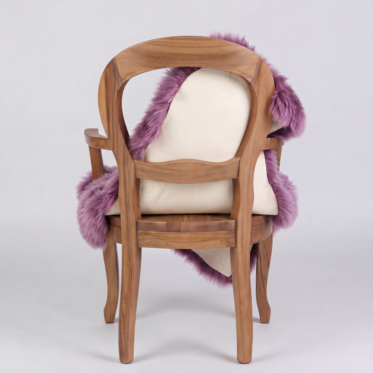 Medici purple sheepskin over an armchair back, suede leather underside facing the camera