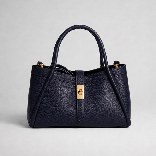 Bianca Leather Mini Bag by Clemés in Navy, three-quarter studio shot on grey background