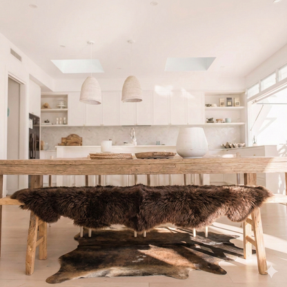 Natural cowhide rug styled on the floor of an editorial interior room
