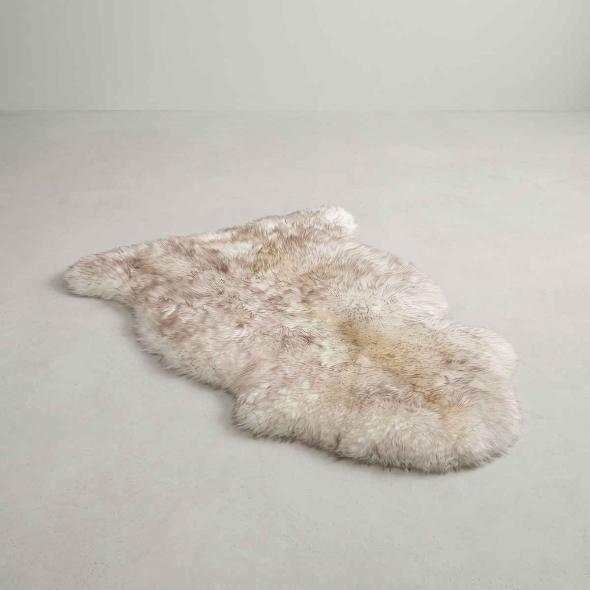 Wolf Tip single sheepskin rug laid flat on a pale grey floor