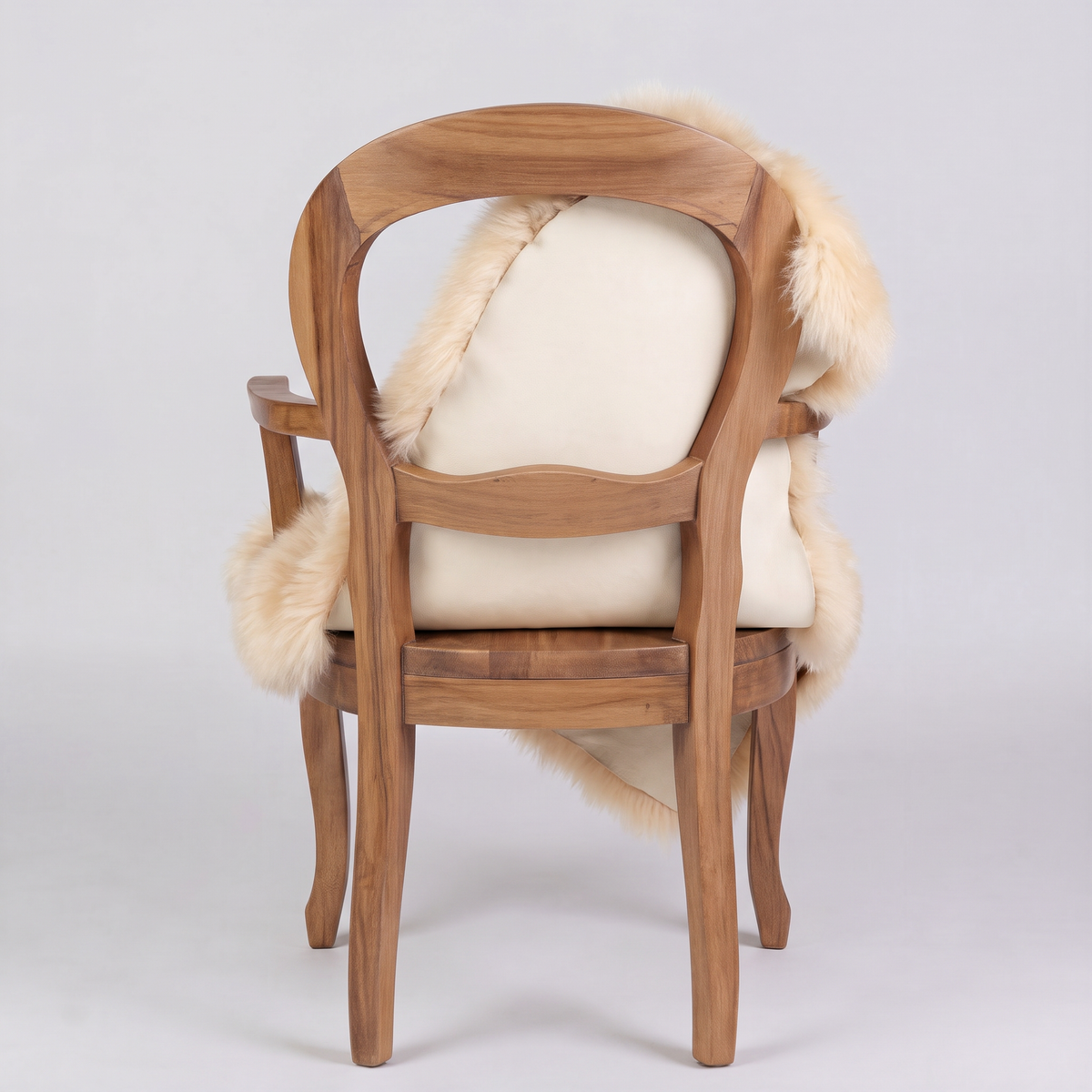 Champagne sheepskin over an armchair back, suede leather underside facing the camera