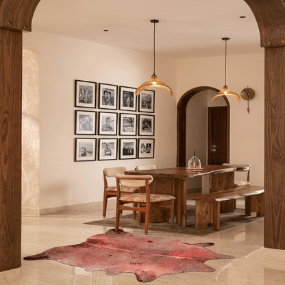 Metallic acid-wash cowhide rug styled on the marble floor of a warm contemporary dining room