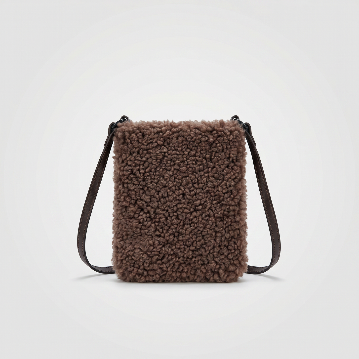 Pia faux shearling crossbody bag in Chocolate on light grey studio background