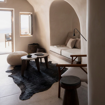 Caramel and ivory exotic printed cowhide rug styled on the floor of an editorial interior