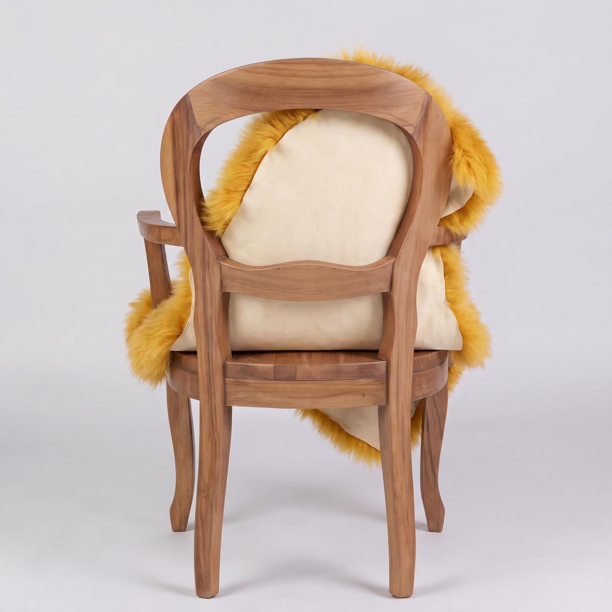 Squash sheepskin over an armchair back, suede leather underside facing the camera
