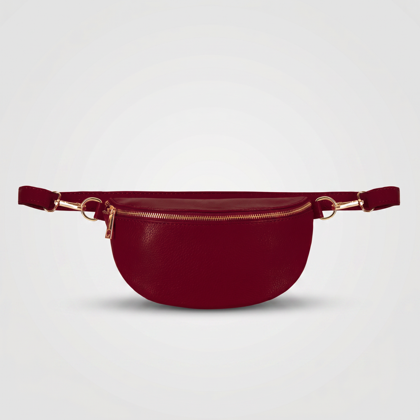Romy leather crossbody bum bag in Burgundy on light grey studio background