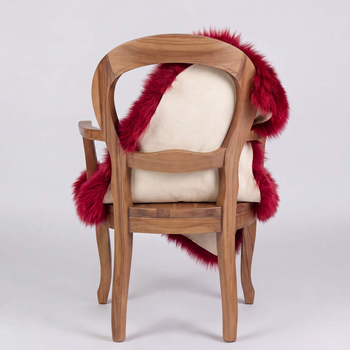 Wildfire red sheepskin over an armchair back, suede leather underside facing the camera