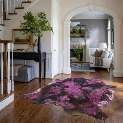 Magenta tie-dye cowhide rug styled on the oak floor of an elegant neutral entryway