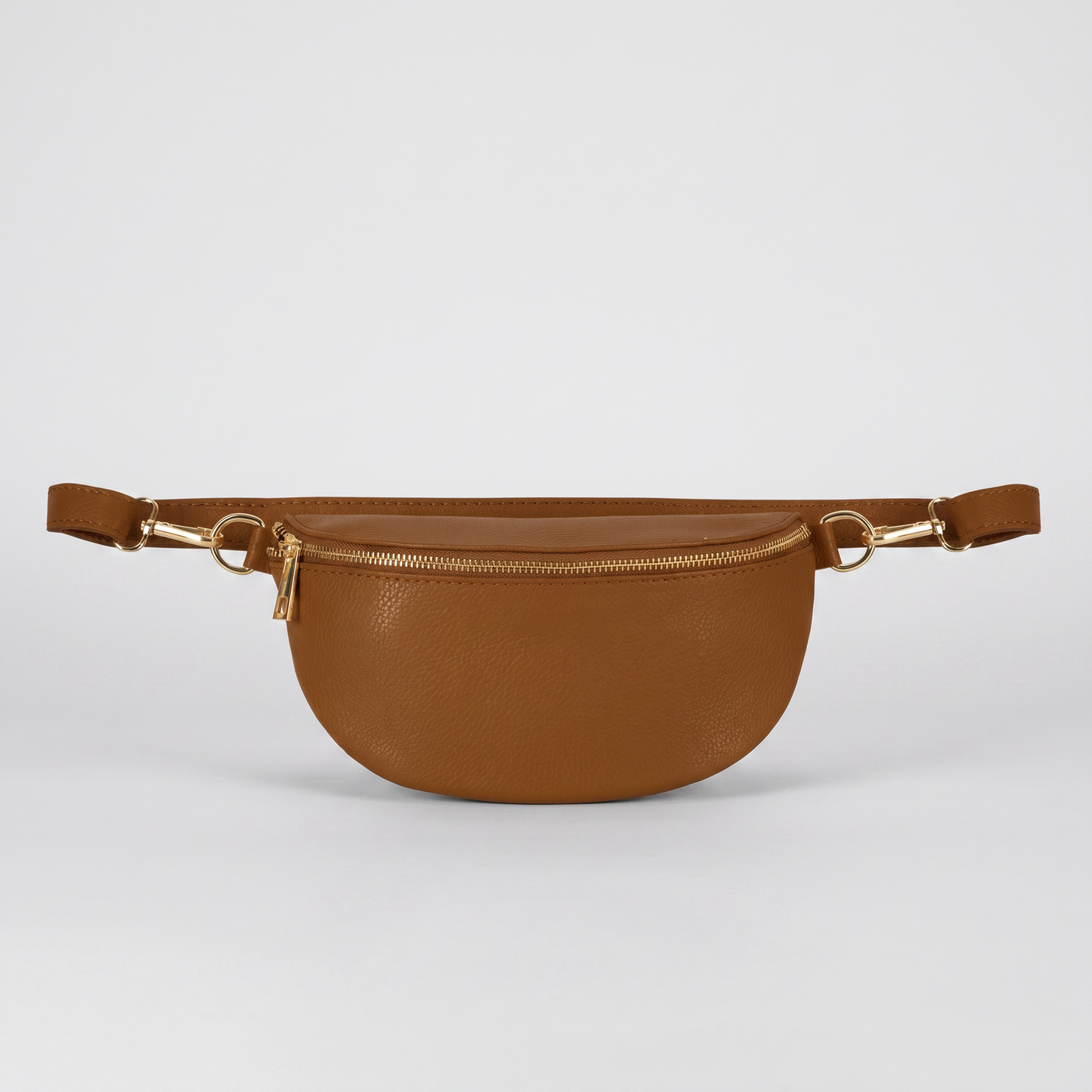 Romy leather crossbody bum bag in Tan on light grey studio background