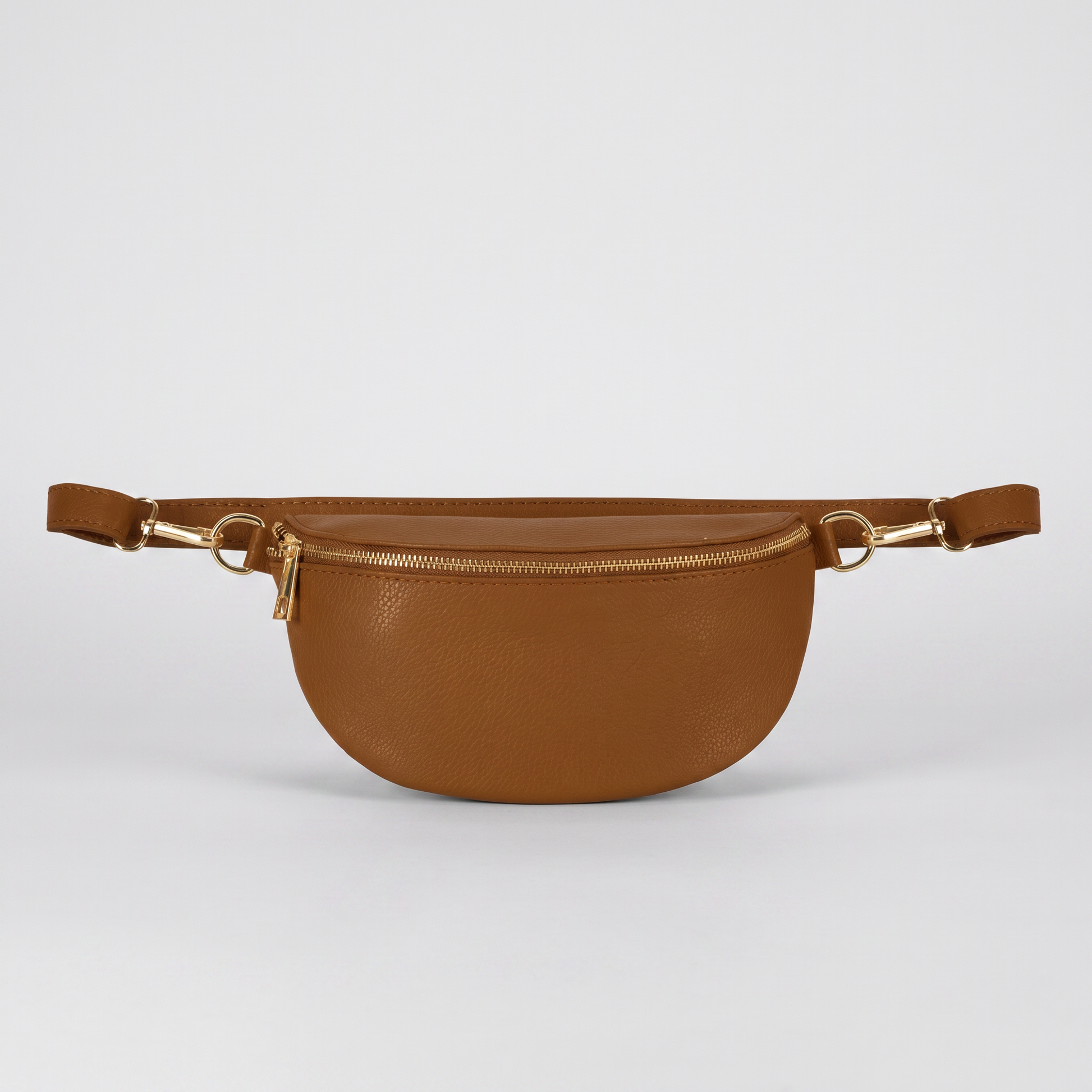 Romy leather crossbody bum bag in Tan on light grey studio background