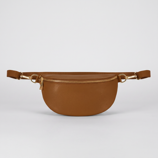 Romy leather crossbody bum bag in Tan on light grey studio background