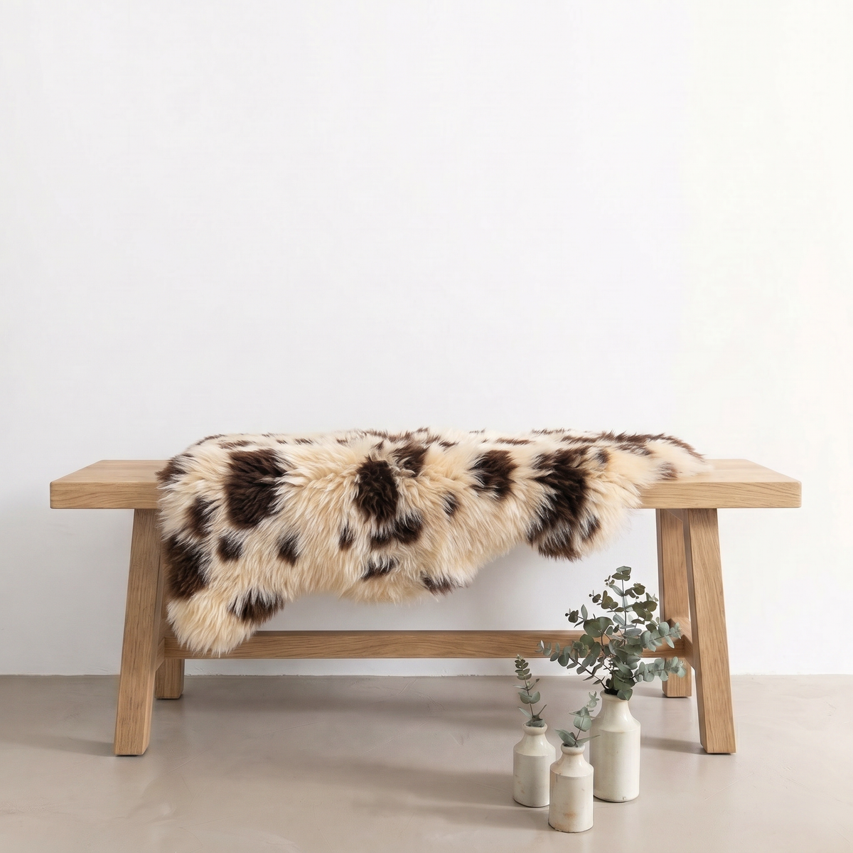 Printed Jacob single sheepskin rug draped over a wooden bench in a styled interior