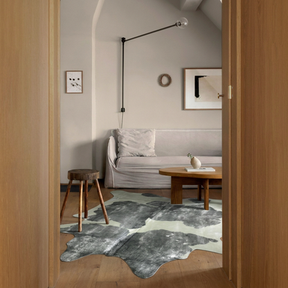 Silver brushed grey and white metallic cowhide rug styled on the oak floor of a minimal attic sitting room