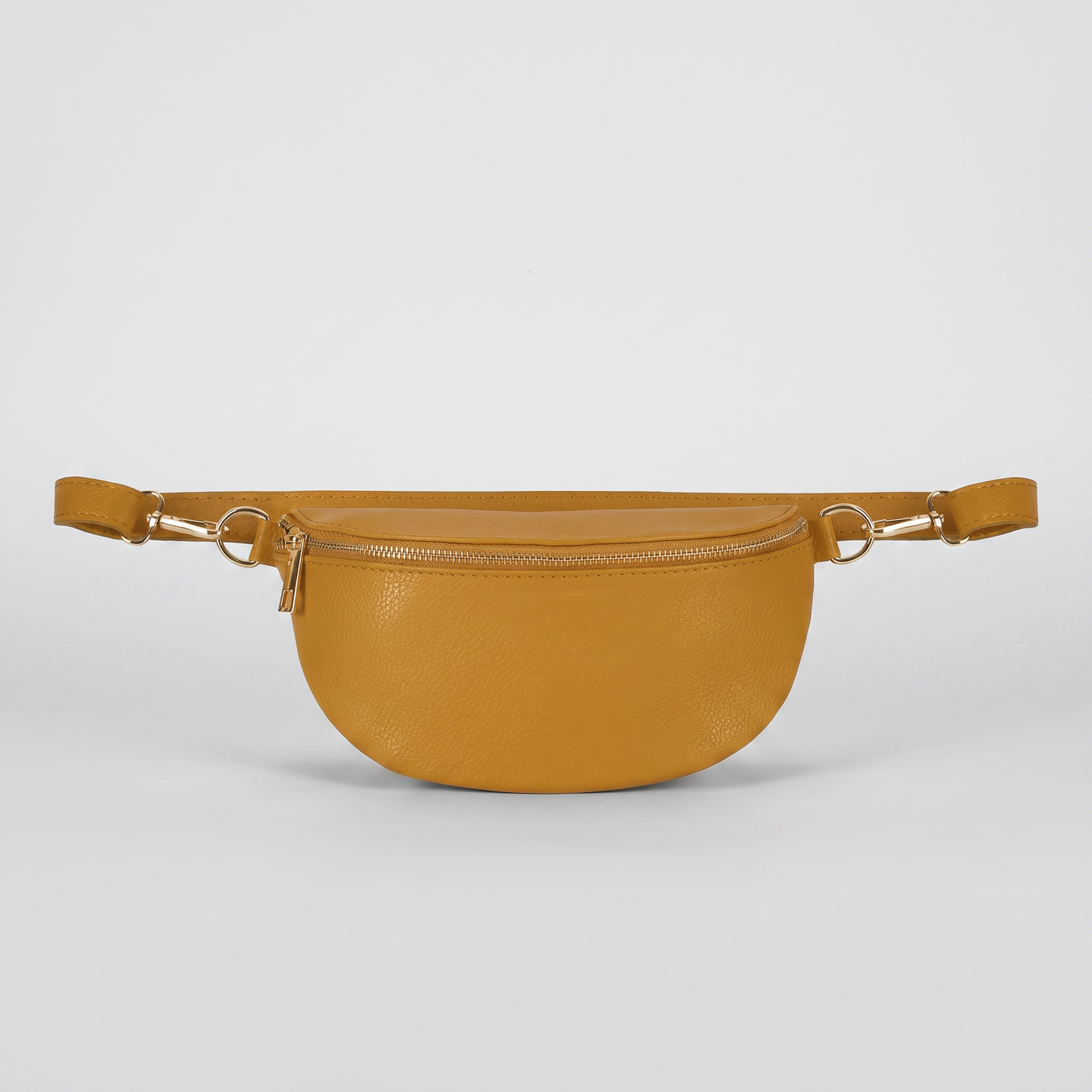 Romy leather crossbody bum bag in Mustard on light grey studio background