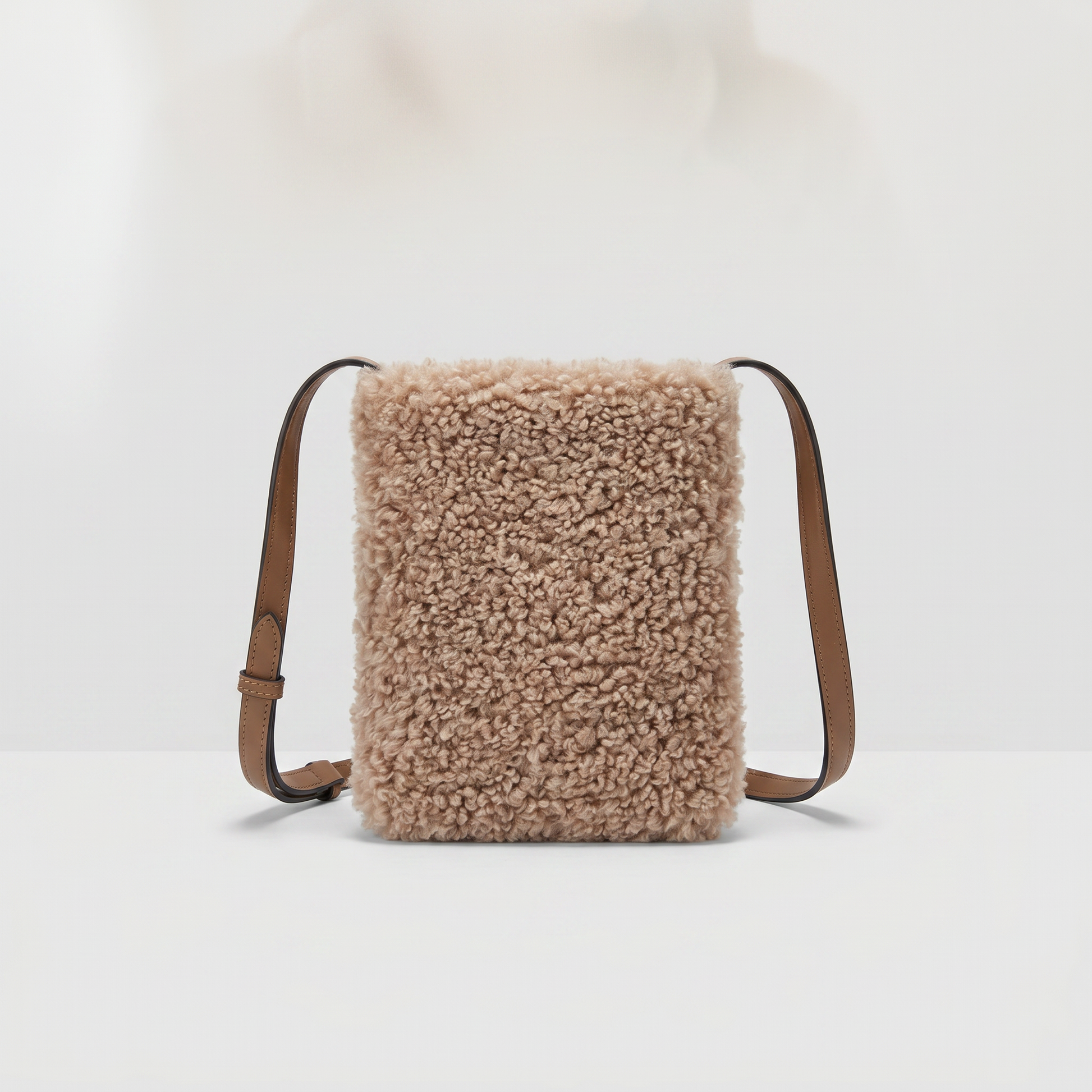Pia faux shearling crossbody bag in Taupe on light grey studio background