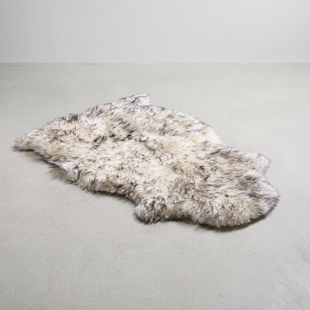 Twilight single sheepskin rug laid flat on a pale grey floor