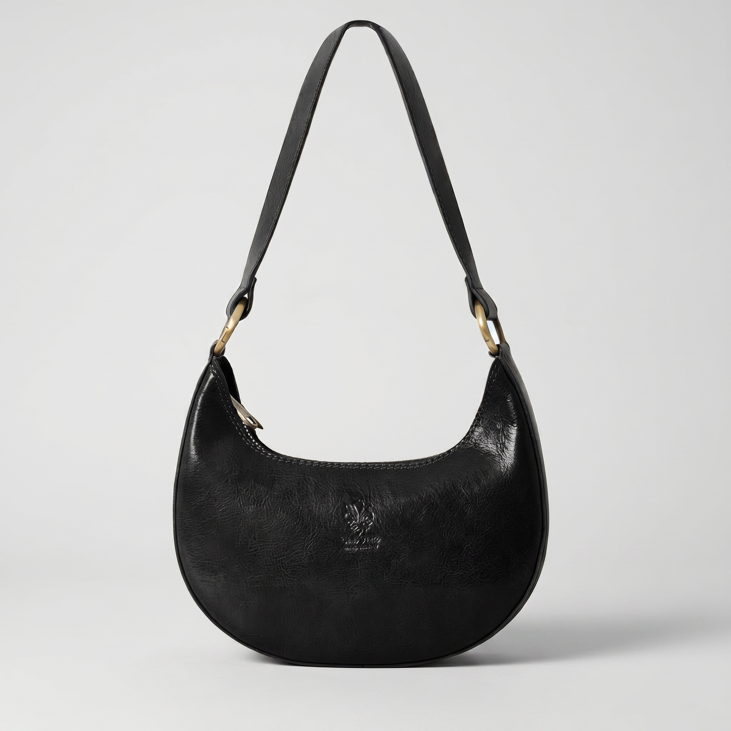 Mezzaluna leather shoulder bag in Black on light grey studio background
