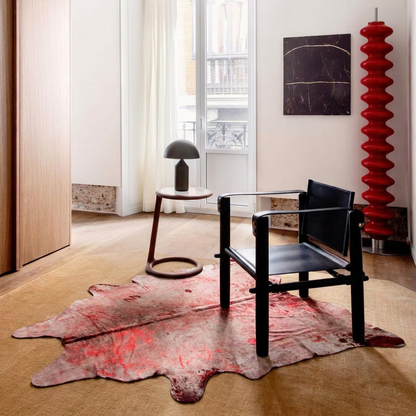 Metallic acid-wash cowhide rug styled on the oak floor of a warm minimal reading corner