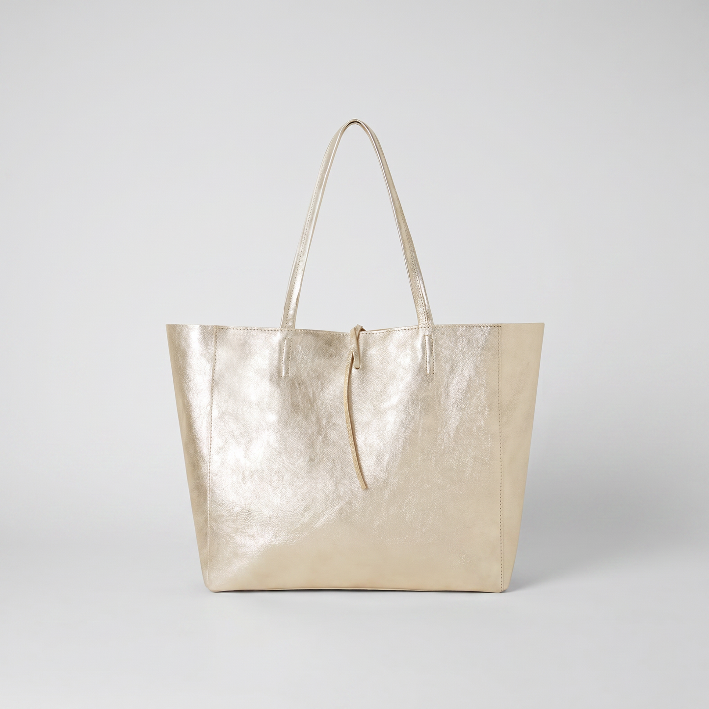 Carlotta Oversized Leather Tote in Gold on light grey studio background