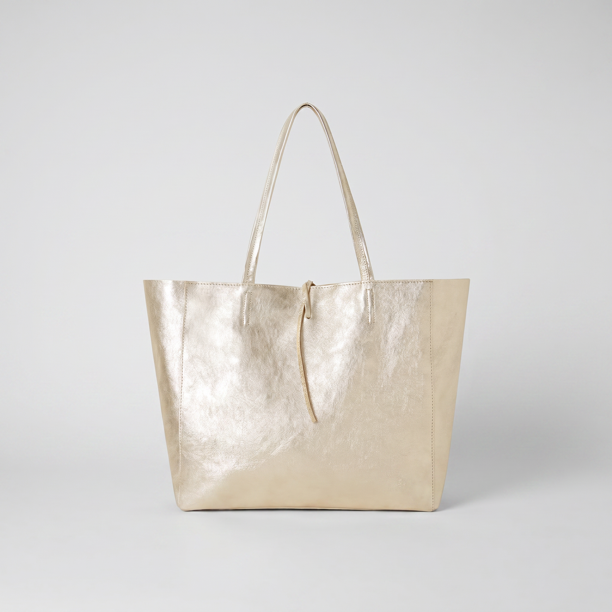 Carlotta Oversized Leather Tote in Gold on light grey studio background