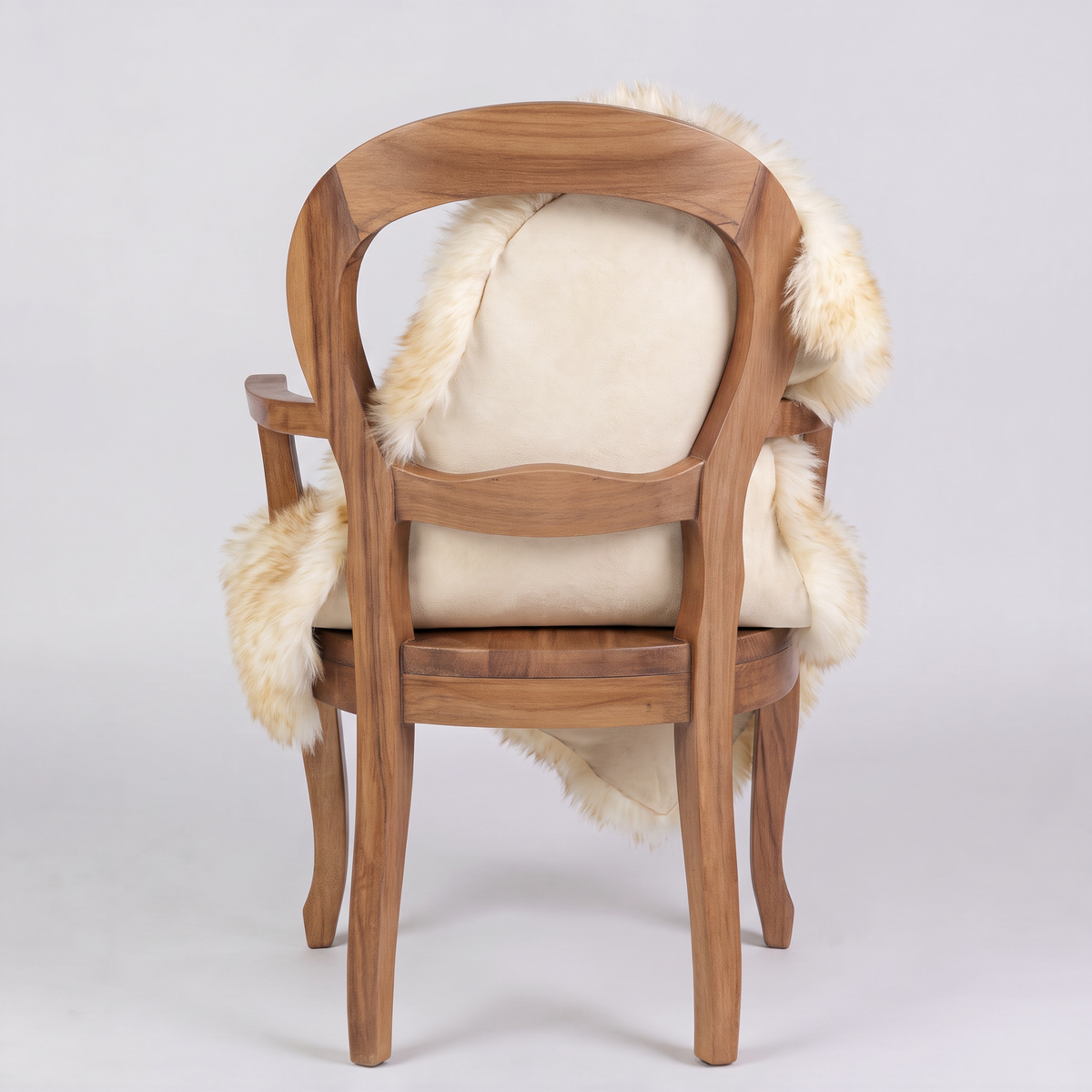 Dusk sheepskin rug over an armchair back, suede leather underside facing the camera