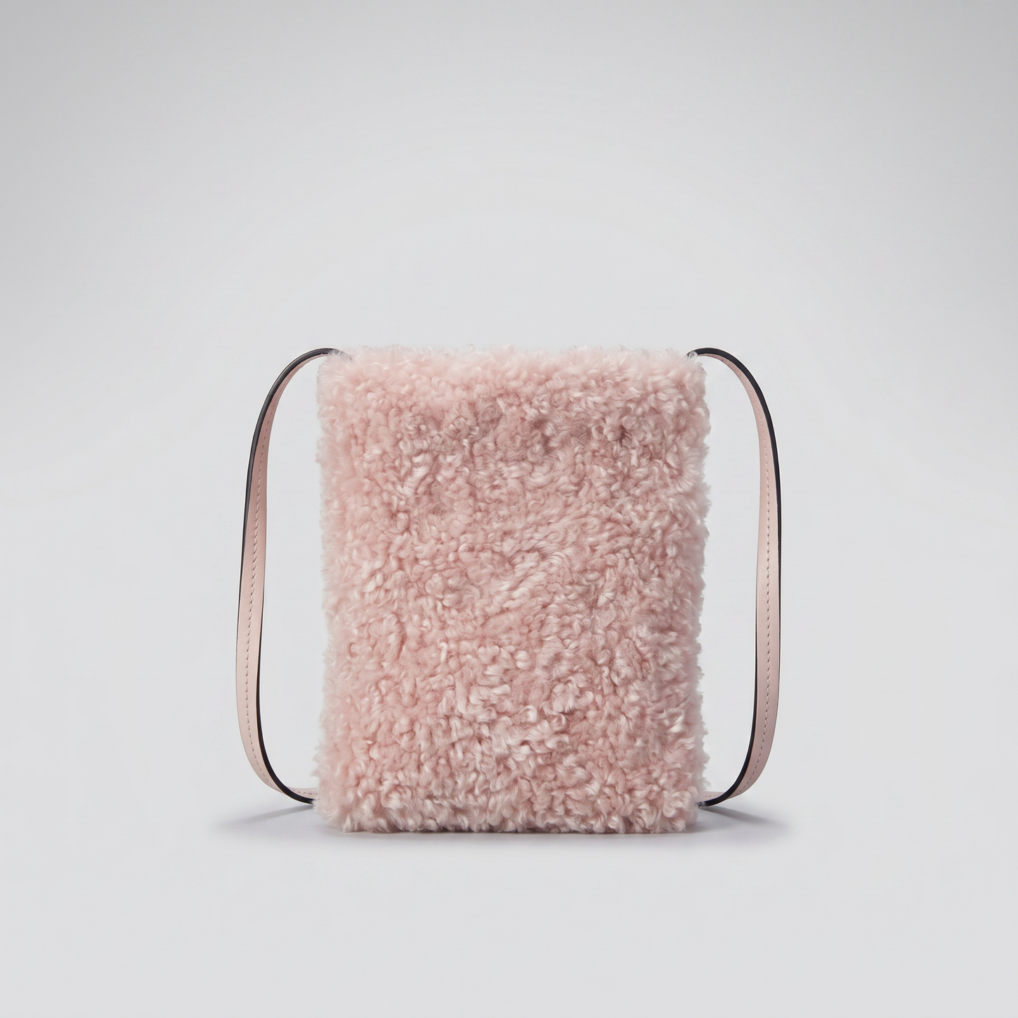 Pia faux shearling crossbody bag in Light Pink on light grey studio background