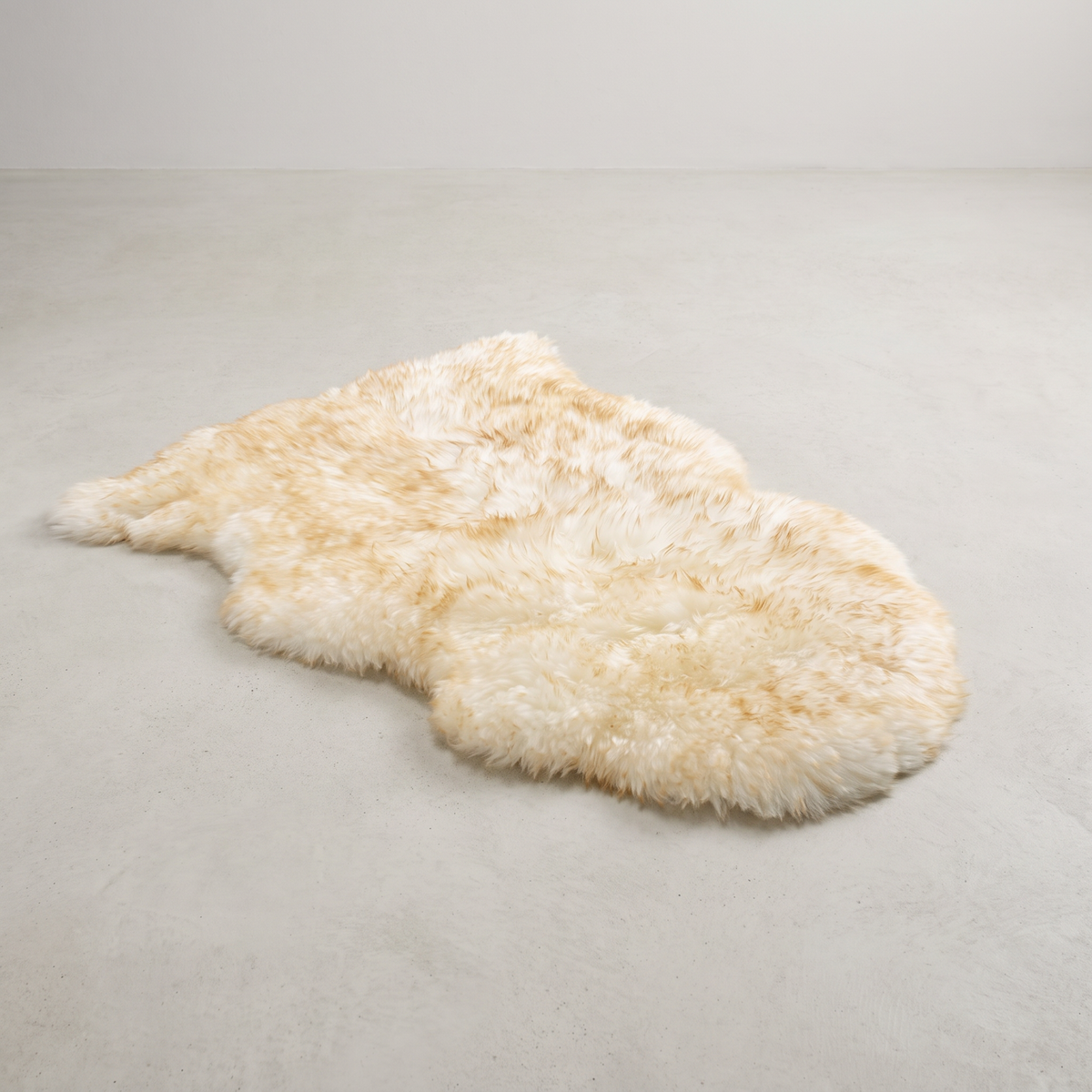 Dusk single sheepskin rug laid flat on a pale grey floor