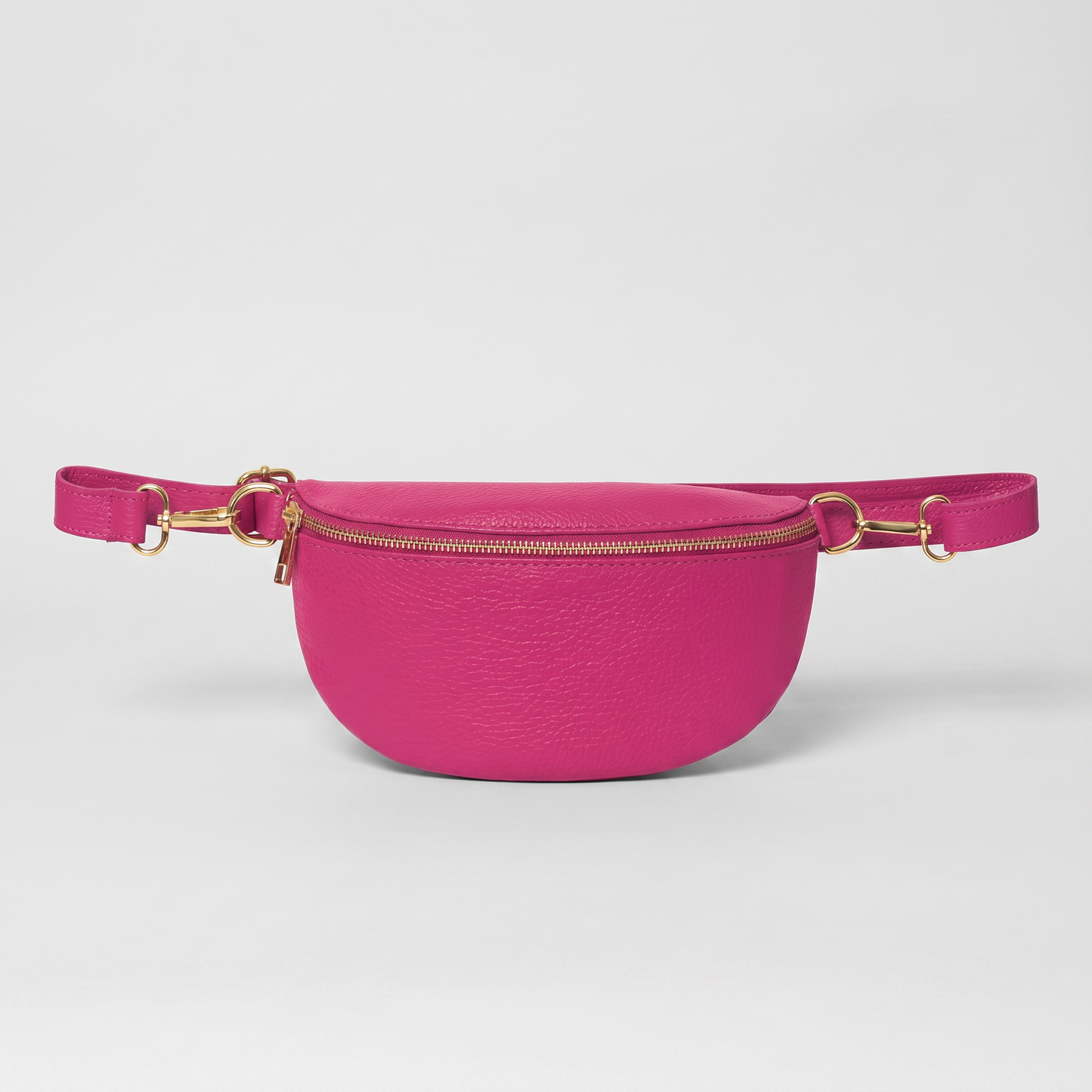 Romy leather crossbody bum bag in Fuchsia on light grey studio background