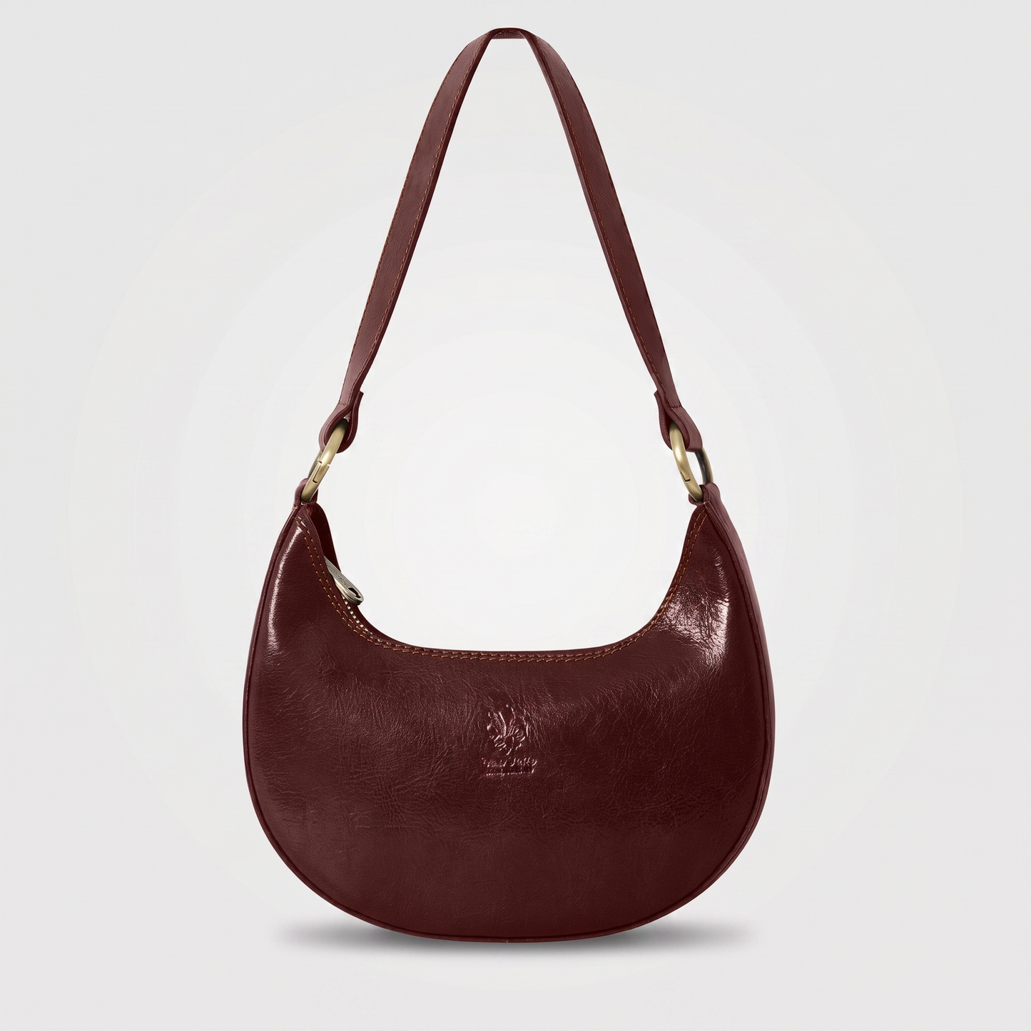 Mezzaluna leather shoulder bag in Chocolate on light grey studio background