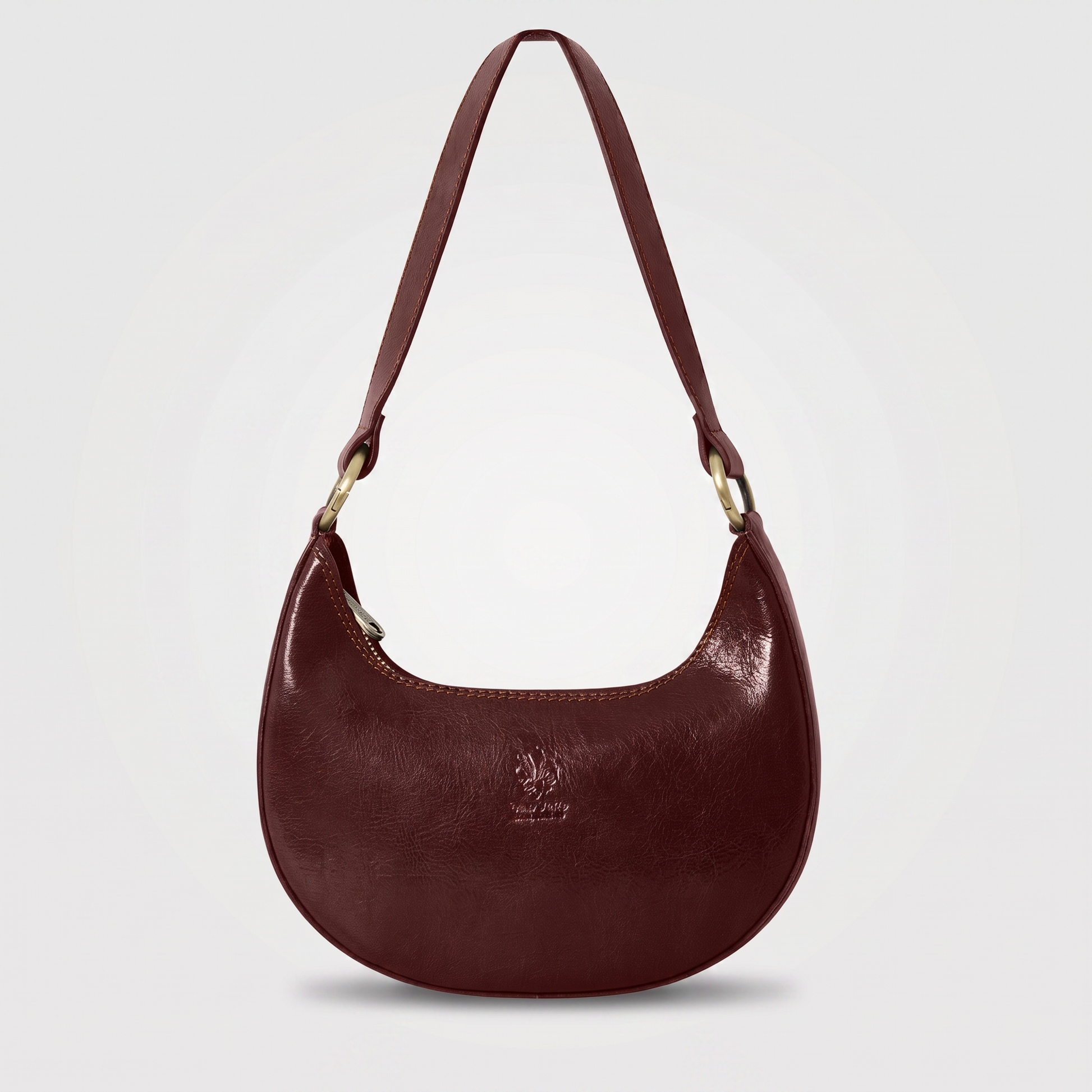 Mezzaluna leather shoulder bag in Chocolate on light grey studio background
