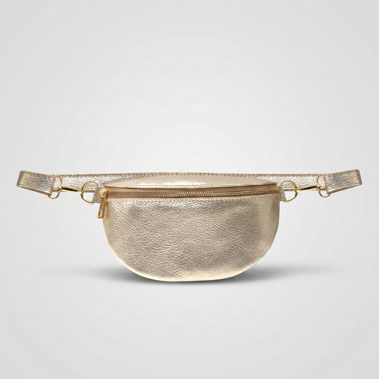 Romy leather crossbody bum bag in Gold on light grey studio background