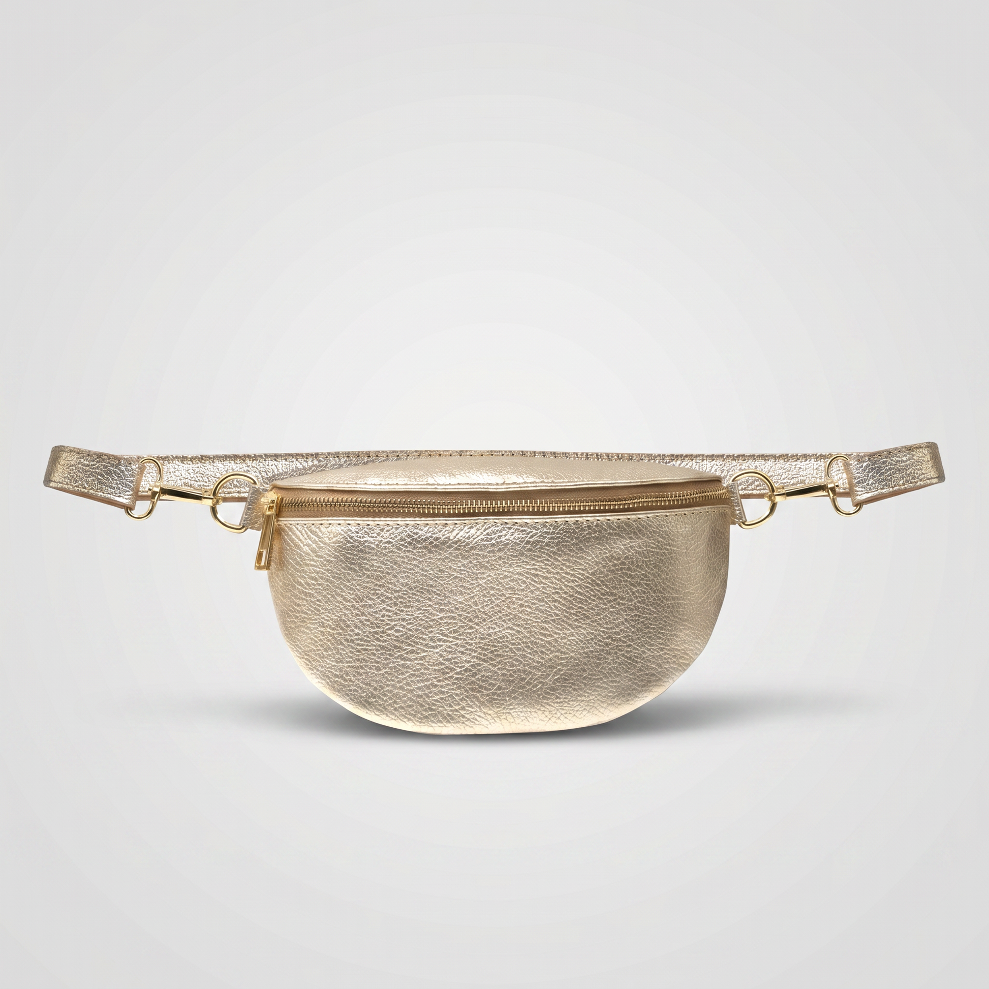 Romy leather crossbody bum bag in Gold on light grey studio background