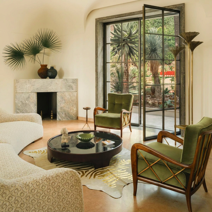 Gold zebra metallic cowhide rug styled under a round coffee table in an Italian villa living room