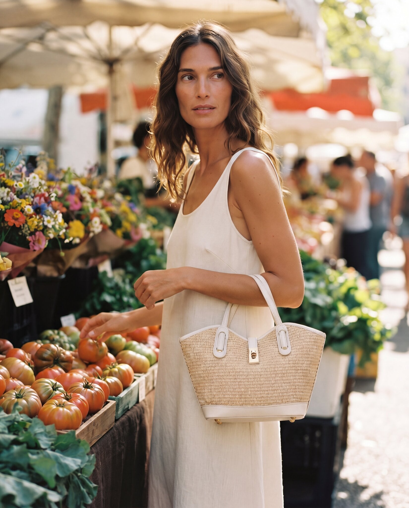 Woman with the Oyster Sorrento Raffia & Leather Tote browsing a sunlit outdoor farmers' market